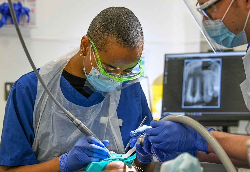 Student on clinic working on patient